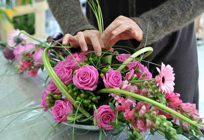 Close-up of florist making bouquet at table