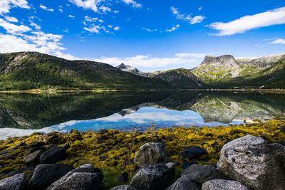 Scenic view of calm lake against rocky mountains