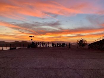 Silhouette of people on street during sunset