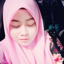 Close-up of young woman wearing pink hijab