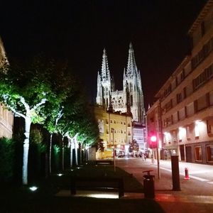 Illuminated temple against sky at night