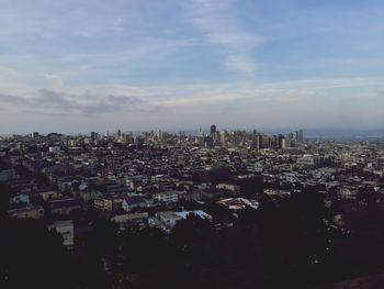 Cityscape against cloudy sky