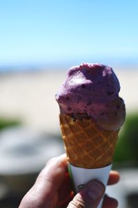 Cropped image of hand holding ice cream cone