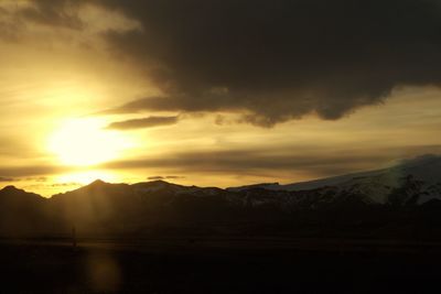 Silhouette of mountain range at sunset