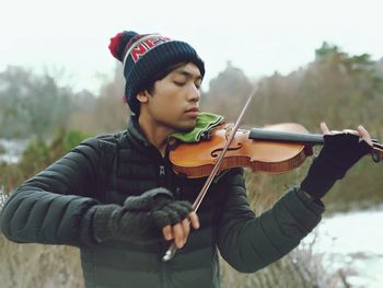 Close-up of young woman playing outdoors