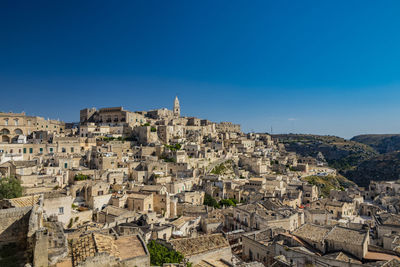 Aerial view of townscape against clear blue sky