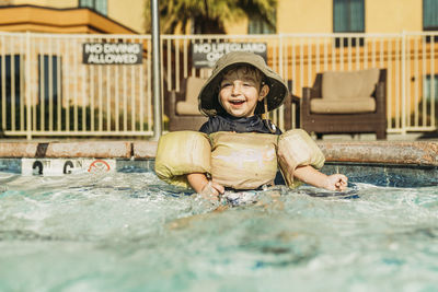 Portrait of happy boy in swimming pool