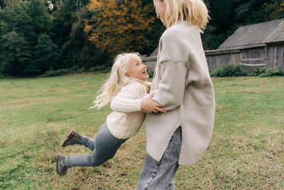 Rear view of woman standing on field