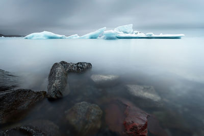 Scenic view of sea against sky during winter