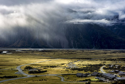 Scenic view of lake by mountains against sky