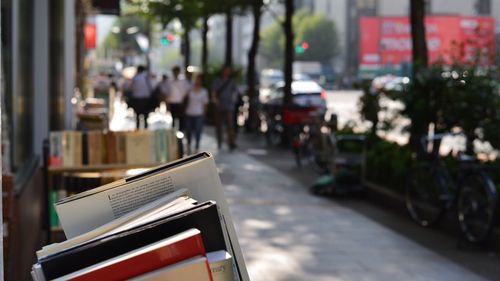 Close up image of books exposed on sidewalk