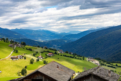 Scenic view of houses and mountains against sky