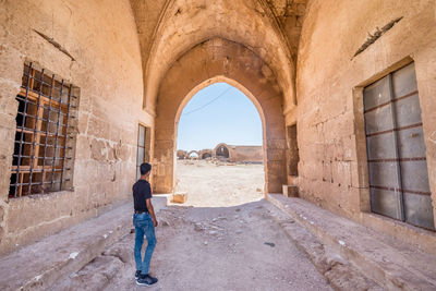 Rear view of man standing against building