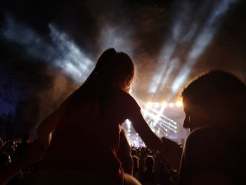 Silhouette people at music concert