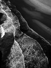 High angle view of rocks on sea shore