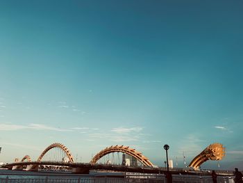 Low angle view of bridge against blue sky