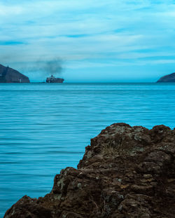 Scenic view of sea against cloudy sky