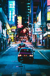 Cars on city street at night