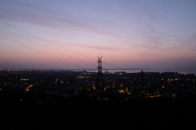 High angle view of illuminated buildings against sky at sunset