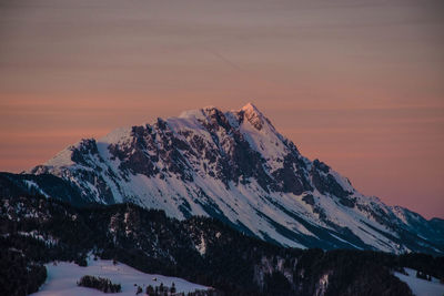 Scenic view of snowcapped mountains against sky during sunset