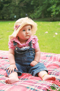 Full length of cute girl sitting on grass