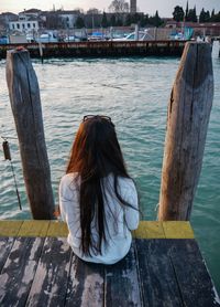 Rear view of woman looking at pier