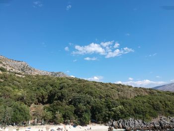 Scenic view of mountains against blue sky