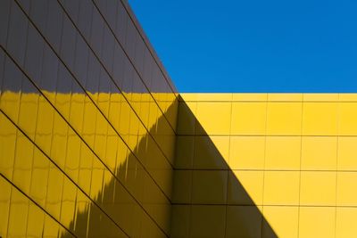 Low angle view of yellow wall against sky