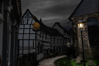 Low angle view of illuminated buildings against sky at dusk