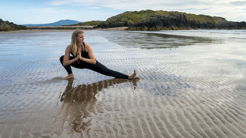 Full length of young woman on beach