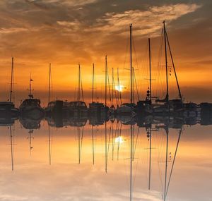 Silhouette sailboats against sky during sunset