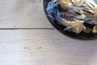 High angle view of chopped fruits in basket on table