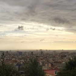 Cityscape against cloudy sky