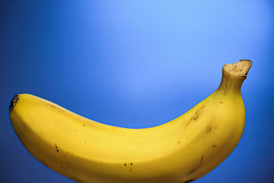 Close-up of banana against blue background