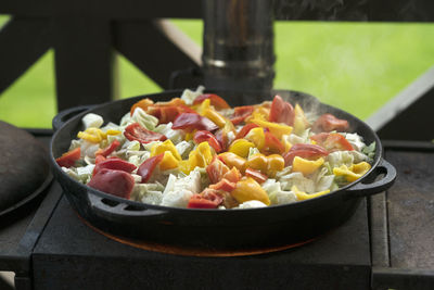 A stew made of red peppers, potatoes, beef, cabbage and other vegetables in a cast-iron cauldron