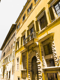 Low angle view of yellow building against sky