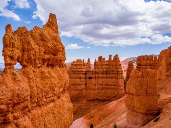 Panoramic view of rock formations against cloudy sky