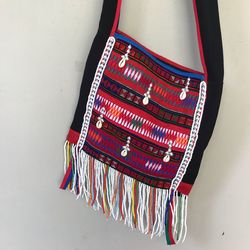 Multi colored bag hanging against wall