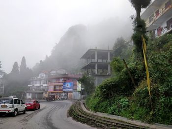 Cars on road amidst buildings in city