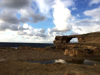 Scenic view of sea against cloudy sky