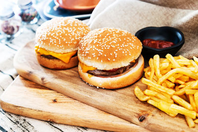 High angle view of burger and french fries on cutting board