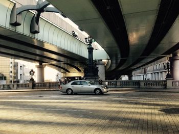 Cars on road amidst buildings in city