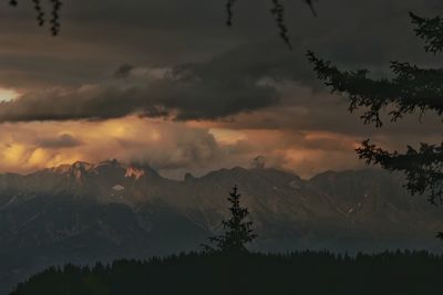 Scenic view of silhouette mountains against sky at sunset