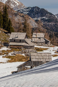 Built structure on snowcapped mountain against sky