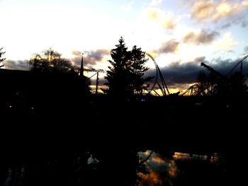 Silhouette trees against sky at sunset