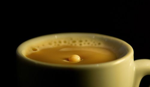 Close-up of coffee cup against black background