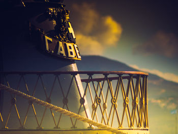 Close-up of crane against sky during sunset