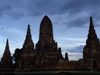 Ancient temple against cloudy sky