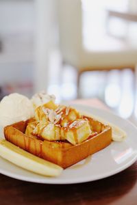 Close-up of bread with honey in plate