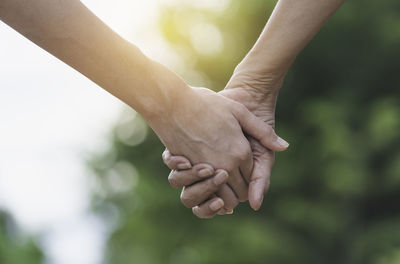 Close-up of couple holding hands